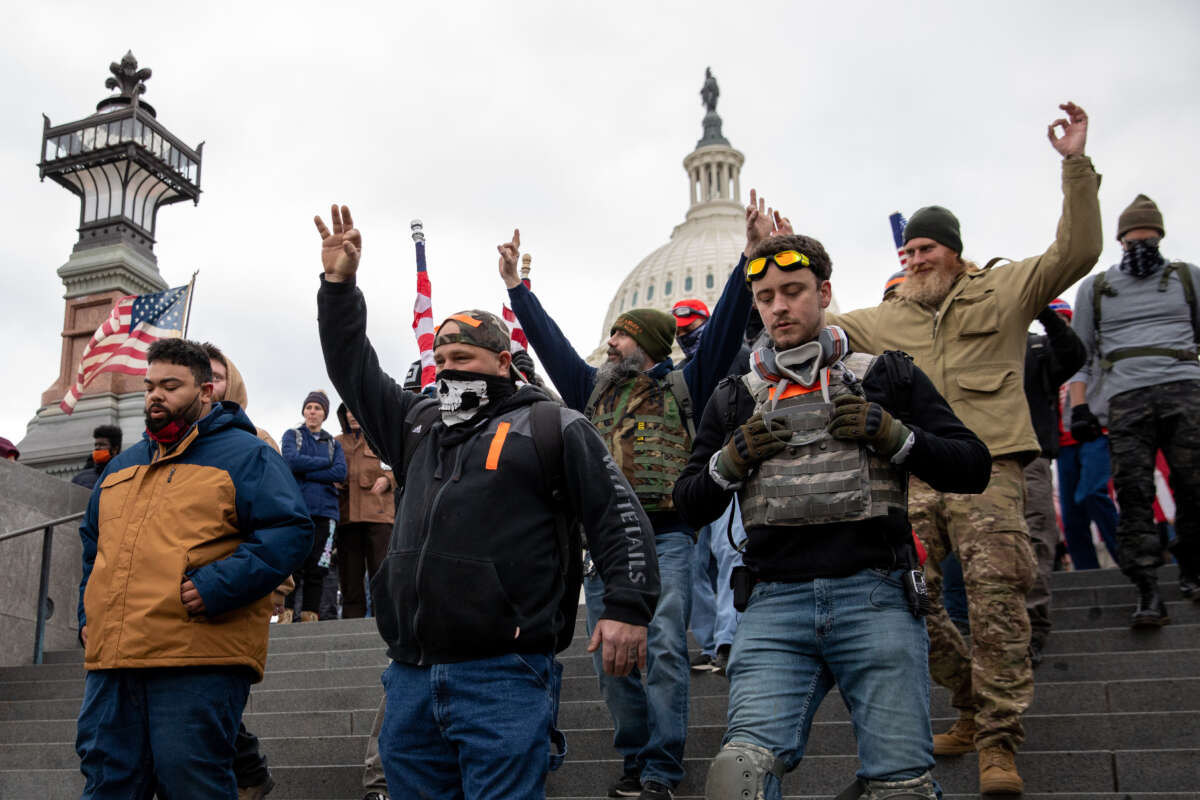 Members of the Proud Boys make hand gestures while walking near the U.S. Capitol in Washington, D.C., on January 6, 2021.