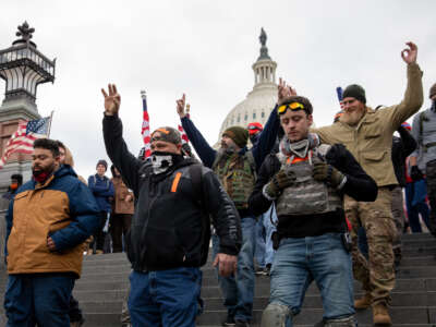 Members of the Proud Boys make hand gestures while walking near the U.S. Capitol in Washington, D.C., on January 6, 2021.