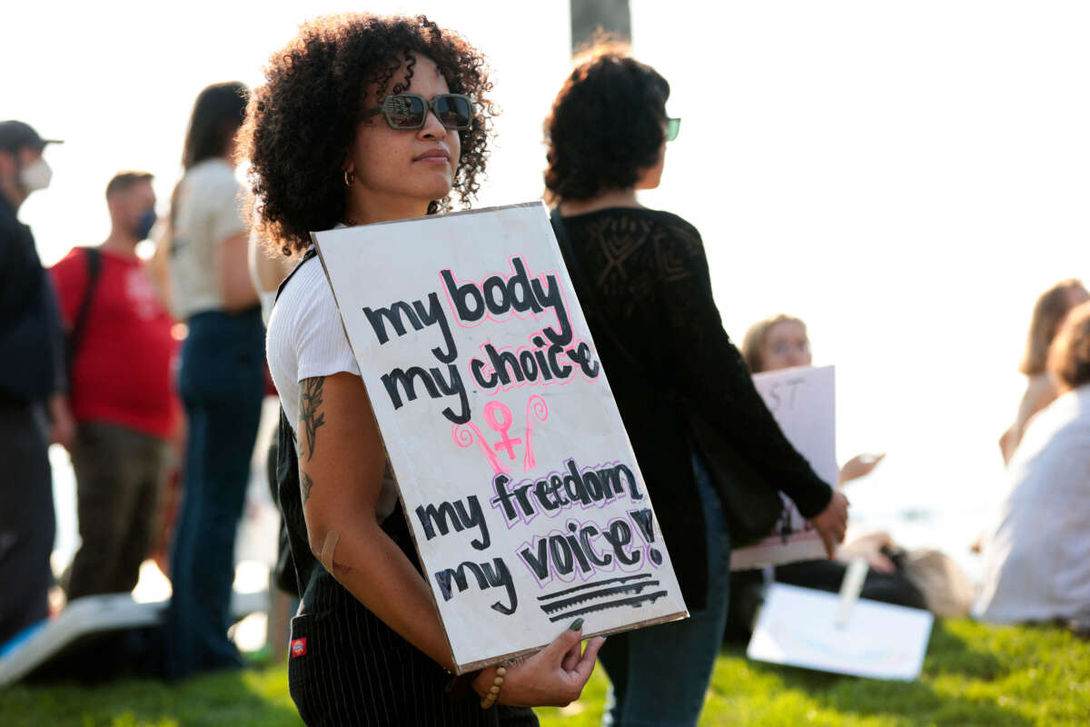 A woman holds an abortion rights sign as people gather at Victor Steinbrueck Park during the Seattle Defends Abortion Rights! rally and march in Seattle, Washington, on October 8, 2022.