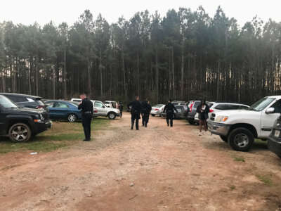 Officers search the parking lot at Intrenchment Creek Park known to the forest defender movement as Weelaunee People's Park.