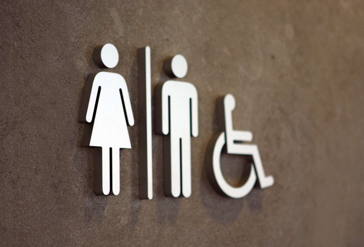 Public restroom sign with outlines of people