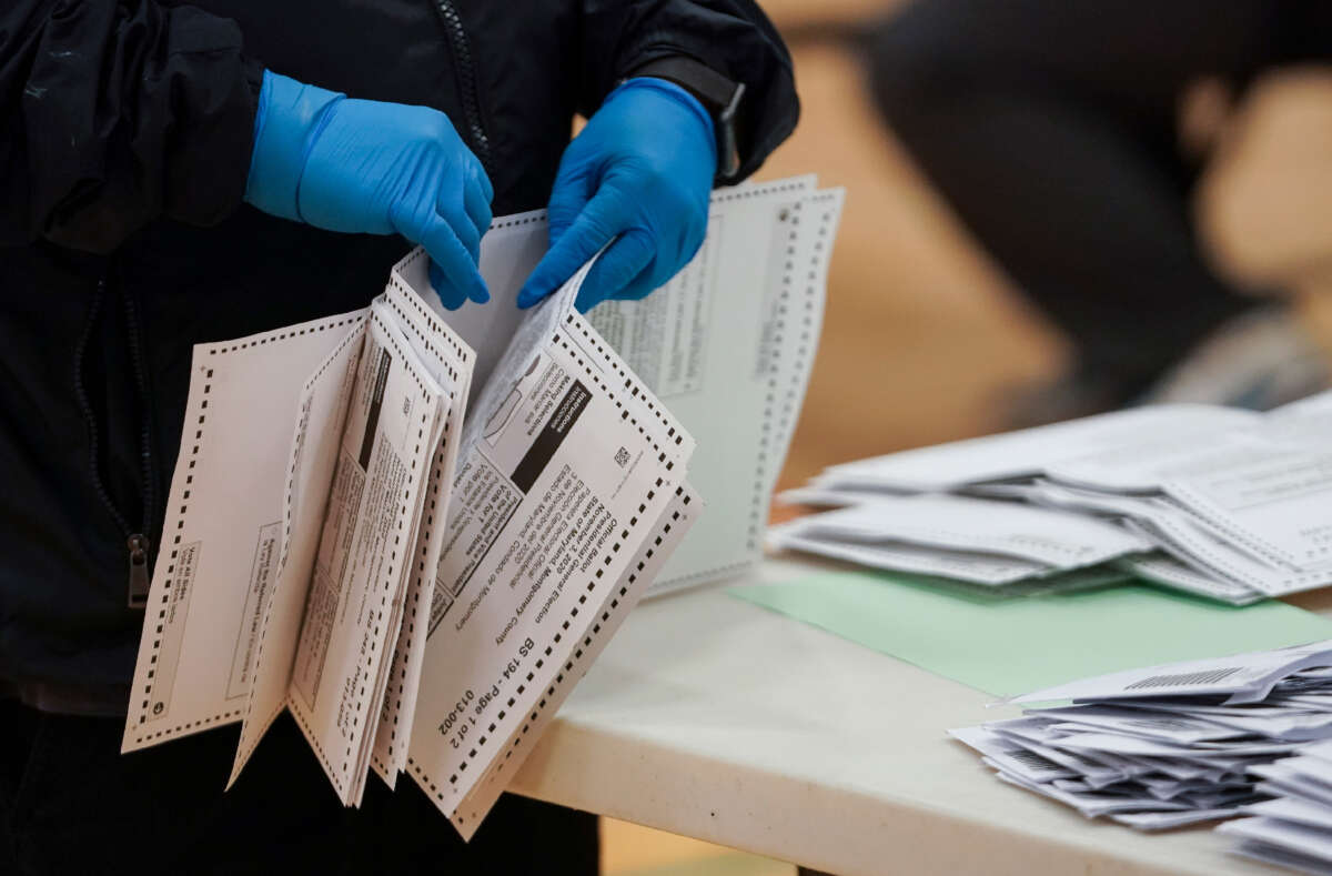 A Montgomery County Board of Elections Canvass worker counts the pages before finishing a batch of ballots while verifying that they have been properly filled out at the Plum Gar Recreation Center on October 13, 2020.