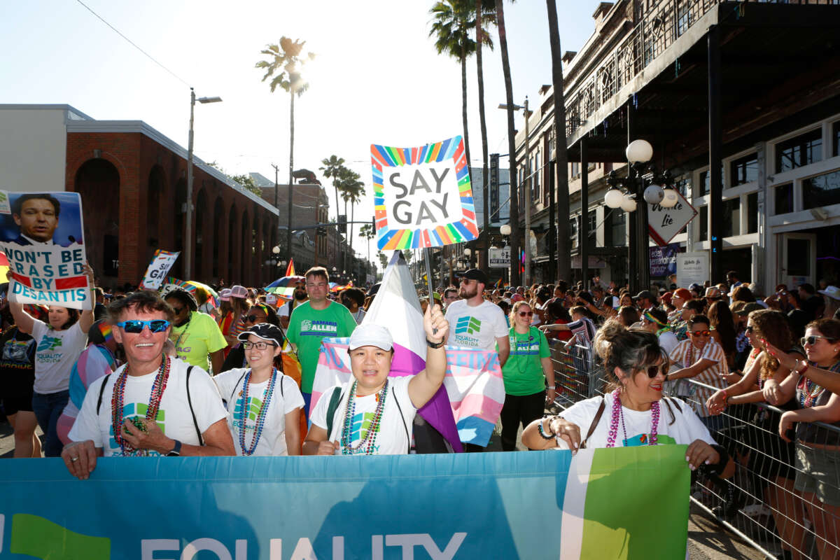 Revelers celebrate on 7th Avenue during the Tampa Pride Parade in the Ybor City neighborhood on March 26, 2022, in Tampa, Florida.