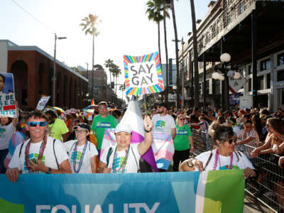 Revelers celebrate on 7th Avenue during the Tampa Pride Parade in the Ybor City neighborhood on March 26, 2022, in Tampa, Florida.