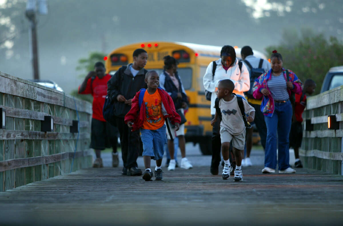 Children on Sapelo Island cross the dock to board the ferry that takes them to the mainland for school.