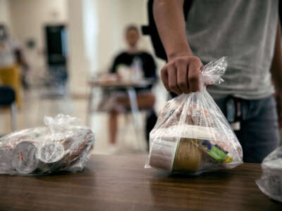 A student picks up a free individually bagged lunch in the cafeteria during the first day of school at Stamford High School on September 8, 2020, in Stamford, Connecticut.