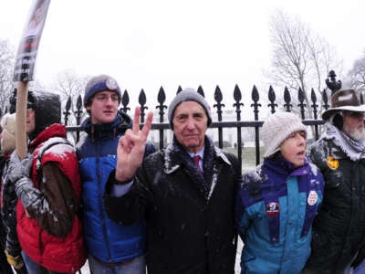 Daniel Ellsberg gives the peace sign during a protest on December 16, 2010, in front of the White House in Washington, D.C.