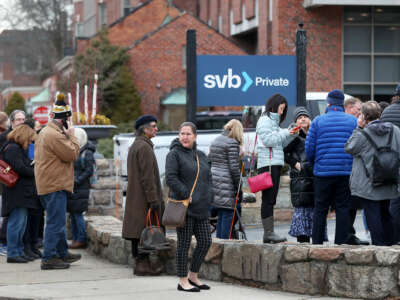 People line up in front of a sign reading "SVB Private"
