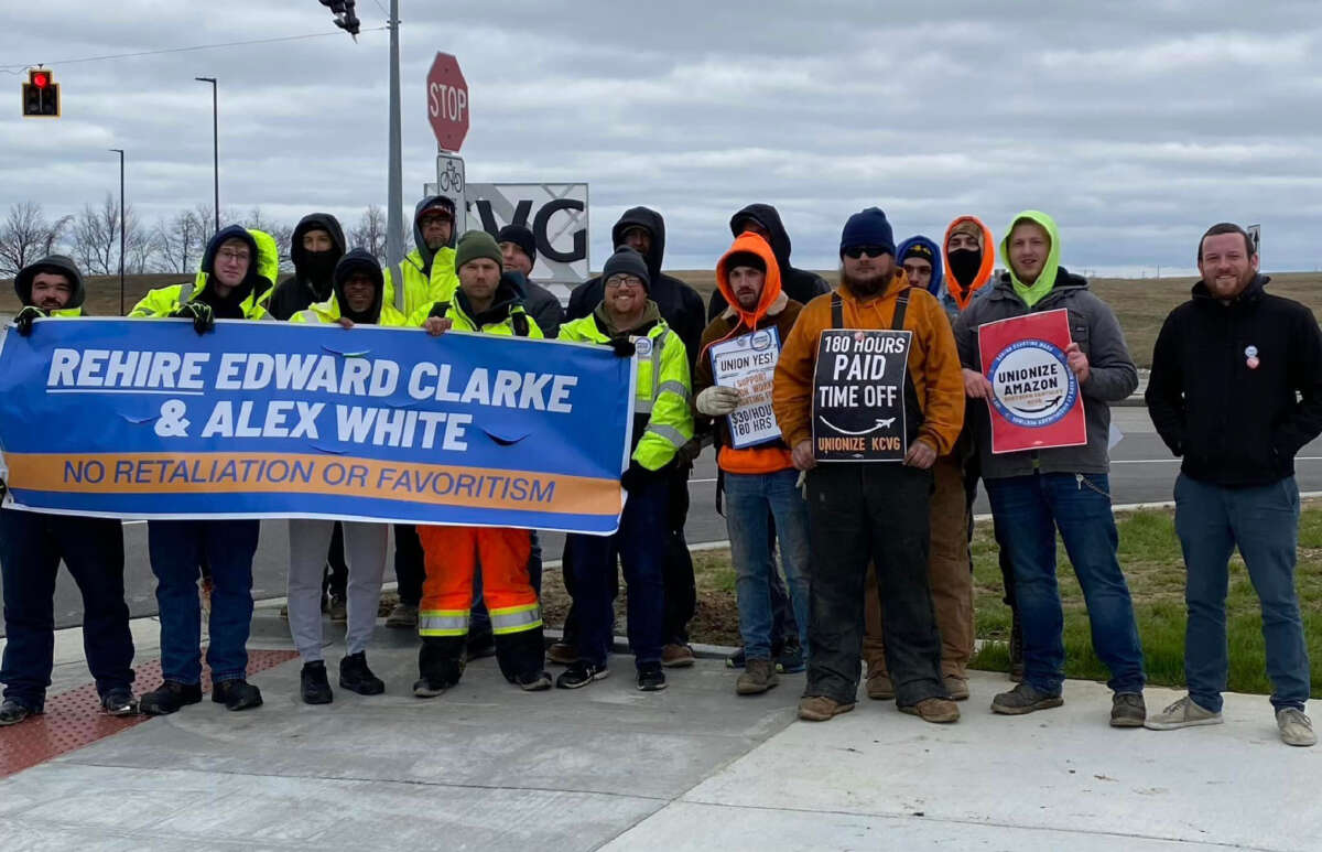 Amazon workers in Northern Kentucky rally with signs calling for a union and the rehiring of Edward Clarke and Alex White