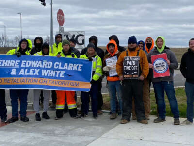 Amazon workers in Northern Kentucky rally with signs calling for a union and the rehiring of Edward Clarke and Alex White