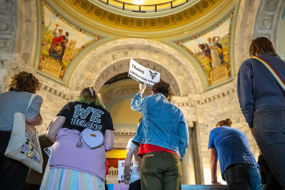 A protester holds a Trans Liberation Now sign during the Fairness Rally at the Kentucky state Capitol on February 15, 2023, in Frankfort, Kentucky.