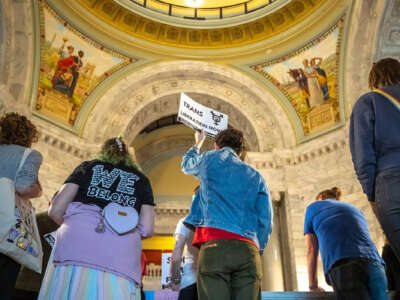 A protester holds a Trans Liberation Now sign during the Fairness Rally at the Kentucky state Capitol on February 15, 2023, in Frankfort, Kentucky.