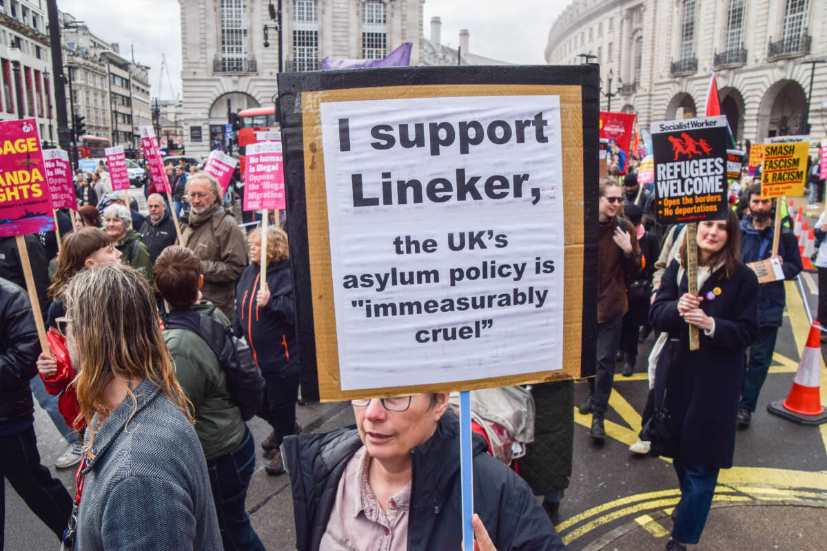 A protester holds a placard in support of Gary Lineker during a demonstration against the U.K.'s asylum policy in Piccadilly Circus in London.