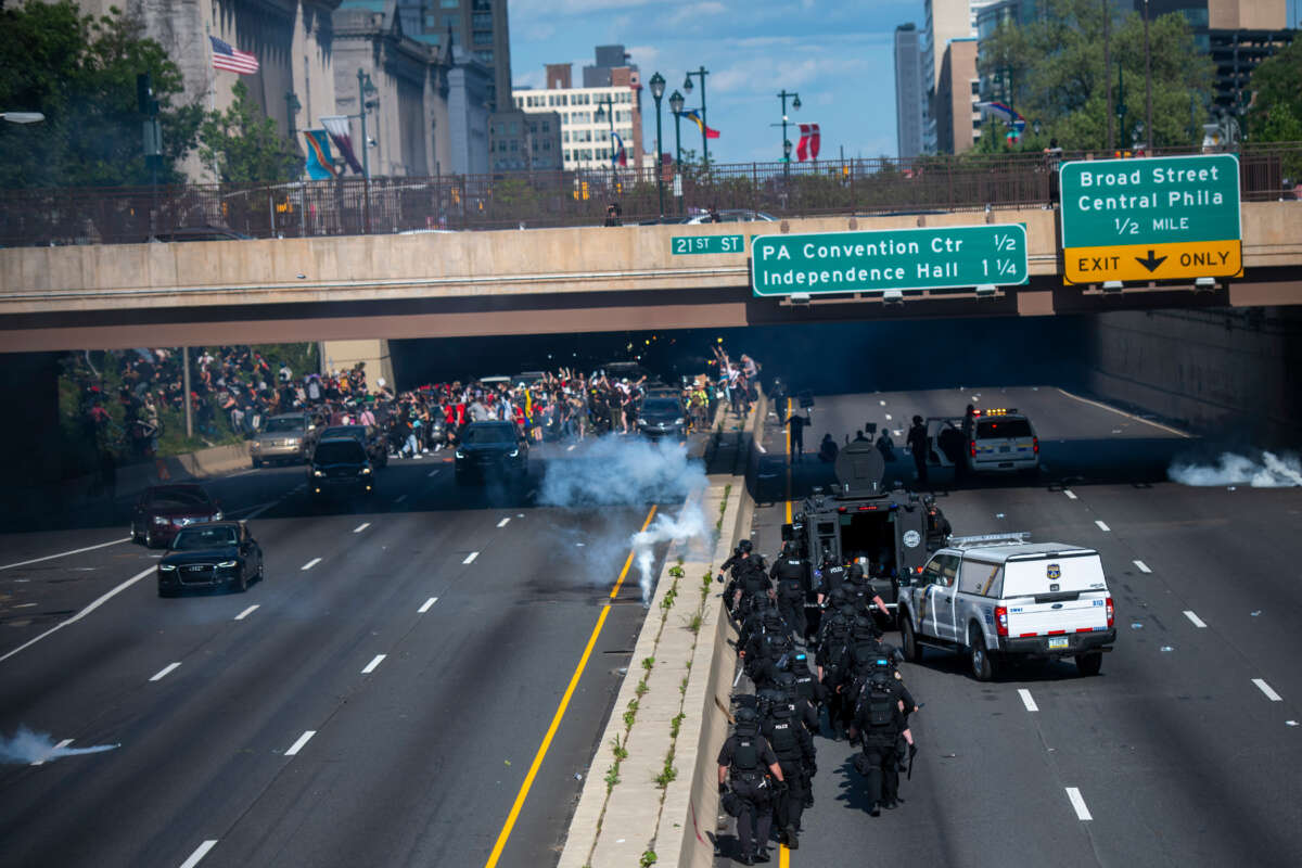 Police officers throw and shoot tear gas into a group of protesters after a march through Center City on June 1, 2020, in Philadelphia, Pennsylvania.