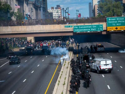 Police officers throw and shoot tear gas into a group of protesters after a march through Center City on June 1, 2020, in Philadelphia, Pennsylvania.