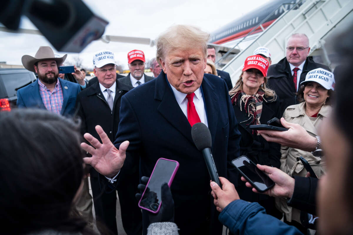 Former President Donald Trump speaks with reporters as he lands at Quad City International Airport in route to Iowa on March 13, 2023, in Moline, Illinois.