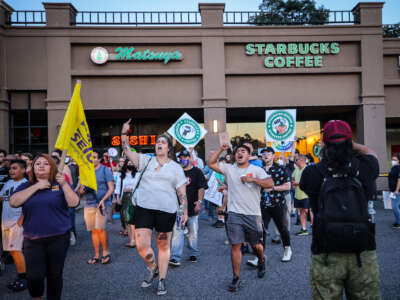 Protestors rally against what they perceive to be union busting tactics, outside a Starbucks in Great Neck, New York, demanding the reinstatement of a former employee, on August 15, 2022.