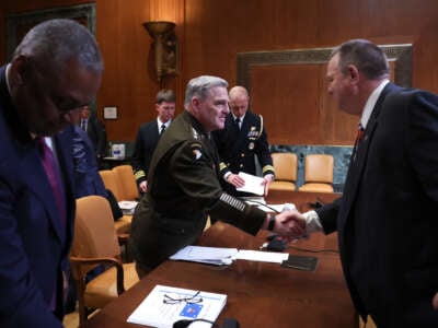 Sen. Jon Tester (right), chairman of the Senate Appropriations Subcommittee on Defense, with Chairman of the Joint Chiefs of Staff Gen. Mark Milley (center) and U.S. Secretary of Defense Lloyd Austin (left) after a hearing before the committee on May 3, 2022, in Washington, D.C.