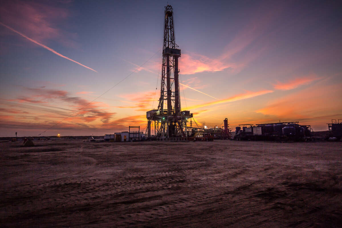 A gas drilling fracking tower is pictured at sunset