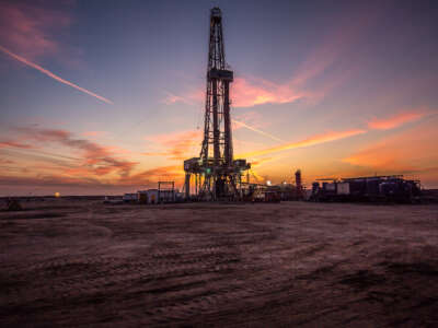 A gas drilling fracking tower is pictured at sunset