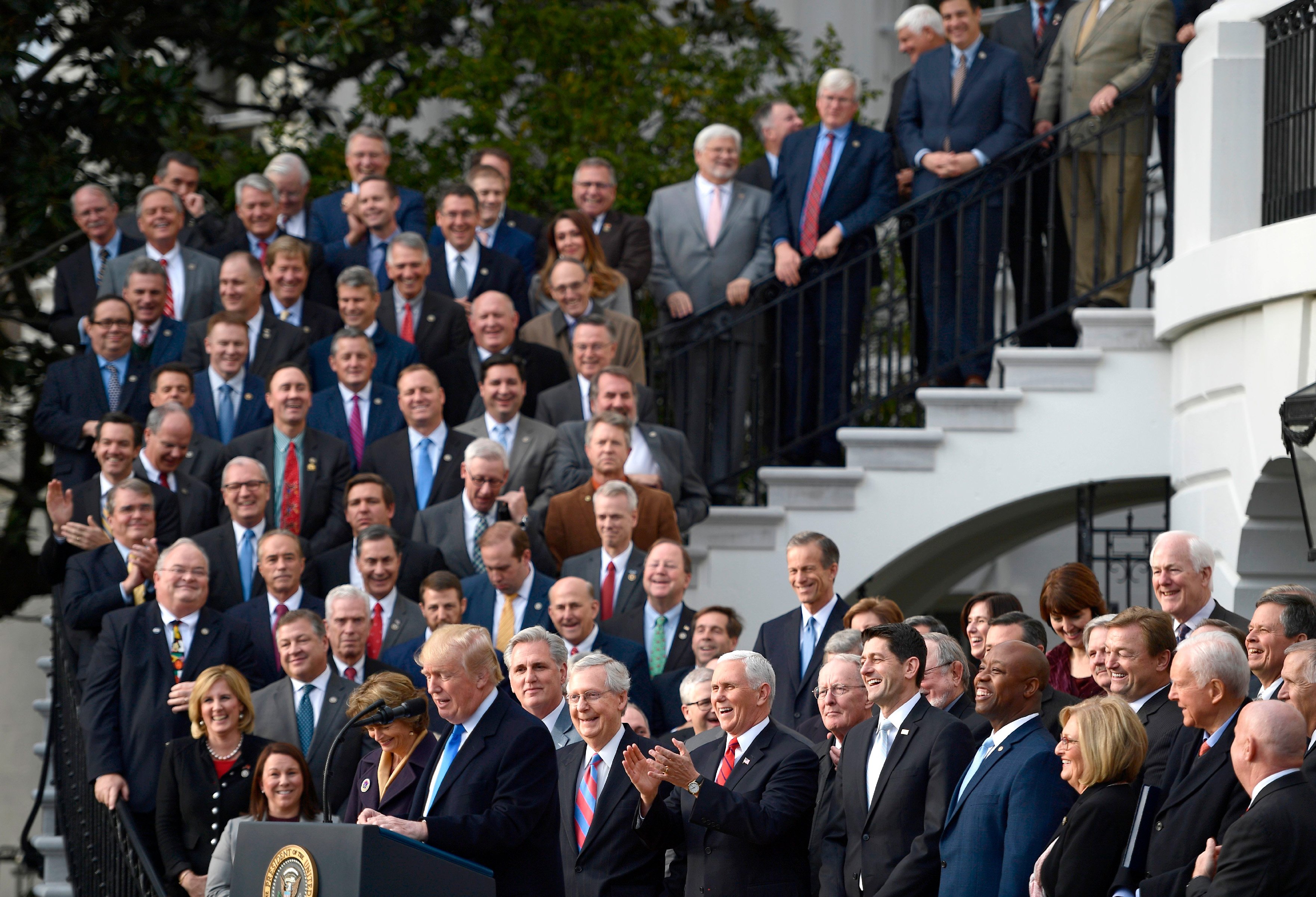 Lawmakers listen to then-President Donald Trump speak about the passage of tax reform legislation on the South Lawn of the White House in Washington, D.C., on December 20, 2017.