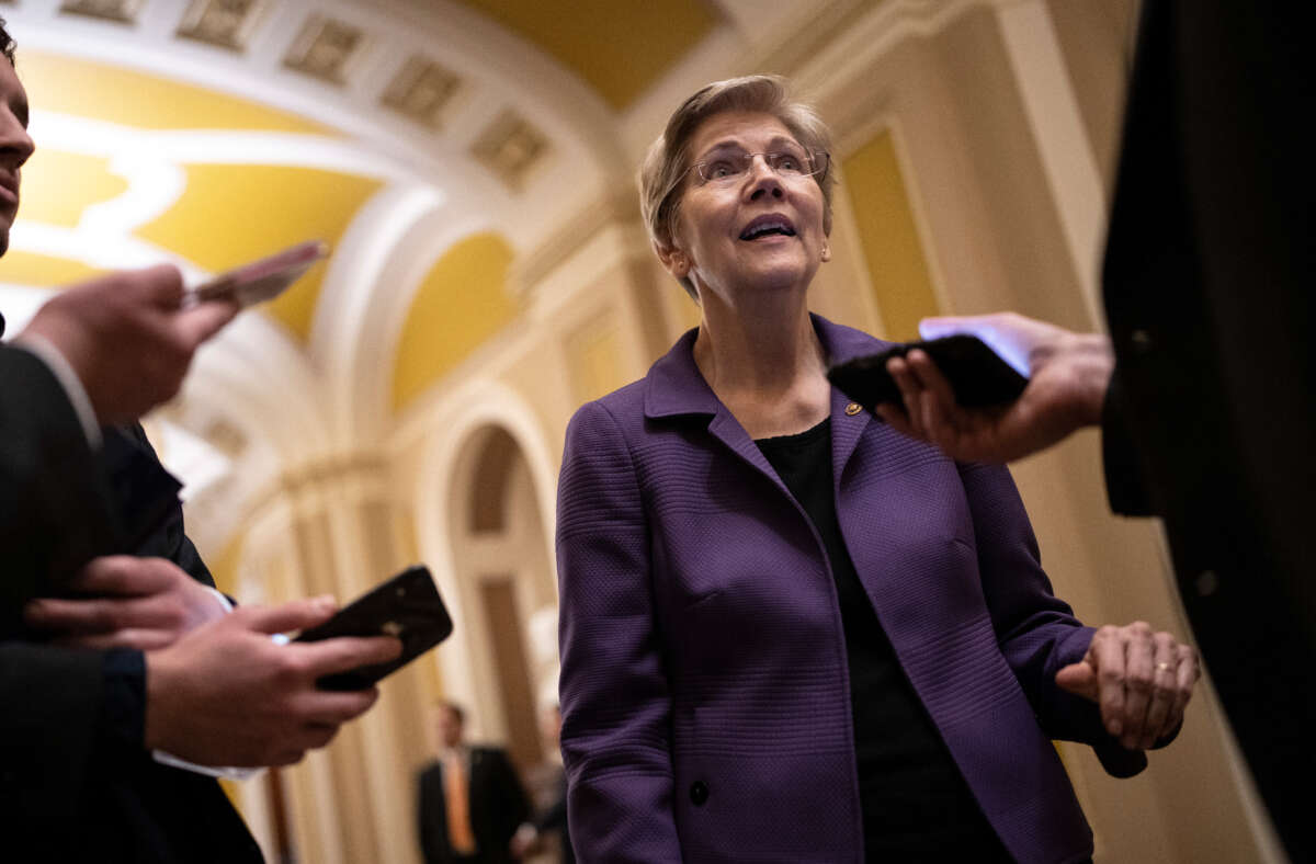 Sen. Elizabeth Warren speaks with reporters on her way to a closed-door lunch meeting with Senate Democrats at the U.S. Capitol on March 22, 2023, in Washington, D.C.