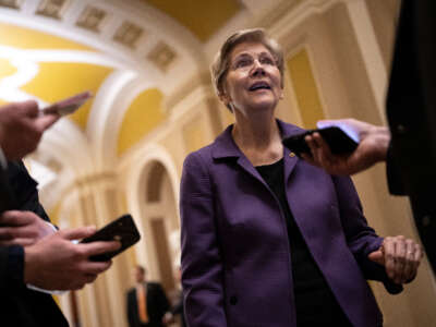 Sen. Elizabeth Warren speaks with reporters on her way to a closed-door lunch meeting with Senate Democrats at the U.S. Capitol on March 22, 2023, in Washington, D.C.