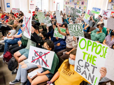 Students against the critical race theory (CRT) ban make their views known while pro-ban speakers talk during the public comment portion of a meeting of the Placentia-Yorba Linda Unified School Board in Placentia, California, on March 23, 2022.