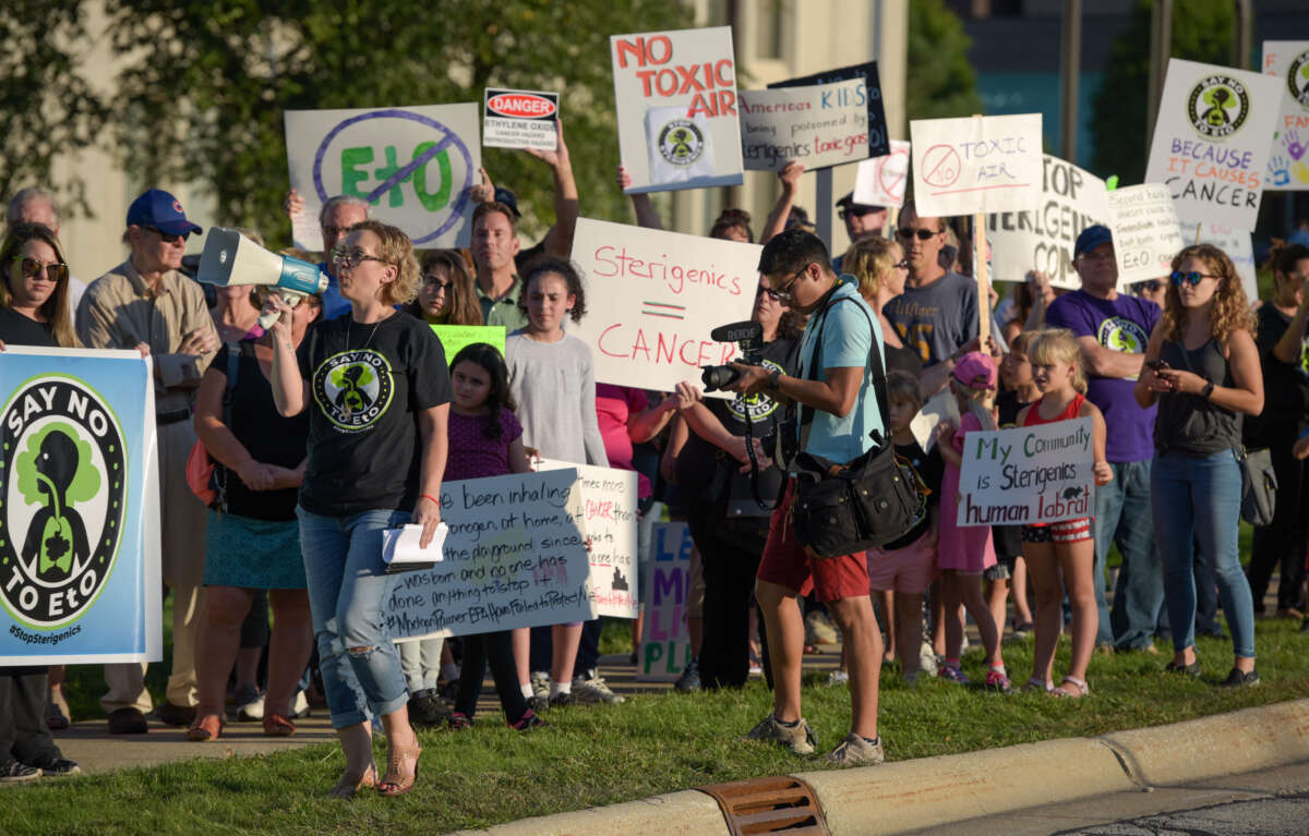 Protesters chant in front of the Oak Brook headquarters of Sterigenics on September 14, 2018, in Oak Brook, Illinois. Sterigenics used carcinogenic ethylene oxide gas in nearby Willowbrook to sterilize items as part of their business.