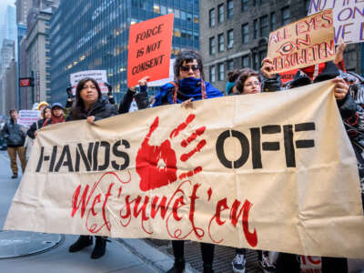 Protesters hold a banner in solidarity with the Wet'suwet'en Nation outside the Canadian Consulate in New York City on February 18, 2020.