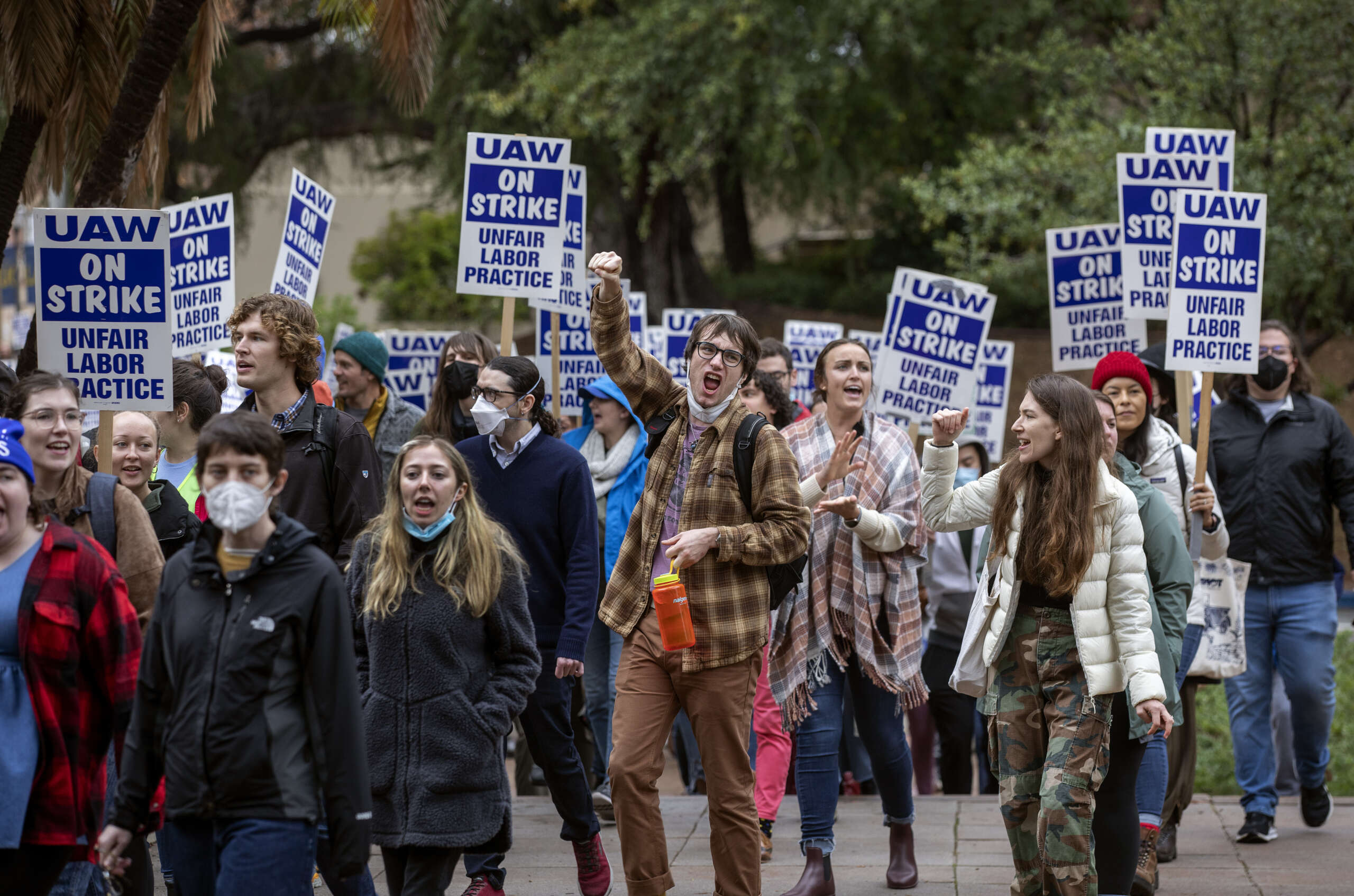 Graduate student workers on strike at UCLA are joined by faculty members as they march together on campus, calling for the university to offer the students a contract with a dramatic increase in pay and benefits to match the skyrocketing cost of living in California, on December 2, 2022, in Los Angeles, California.