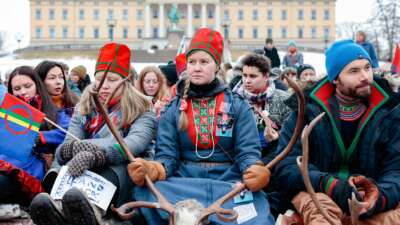 Sami campaigners sit in front of the Royal Castle during a protest