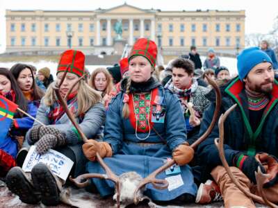 Sami campaigners sit in front of the Royal Castle during a protest
