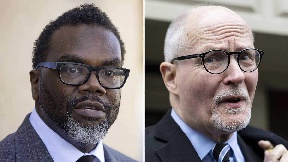 Mayoral candidates Cook County Commissioner Brandon Johnson, left, and former Chicago Public Schools CEO Paul Vallas campaign in Chicago in February, 2023.