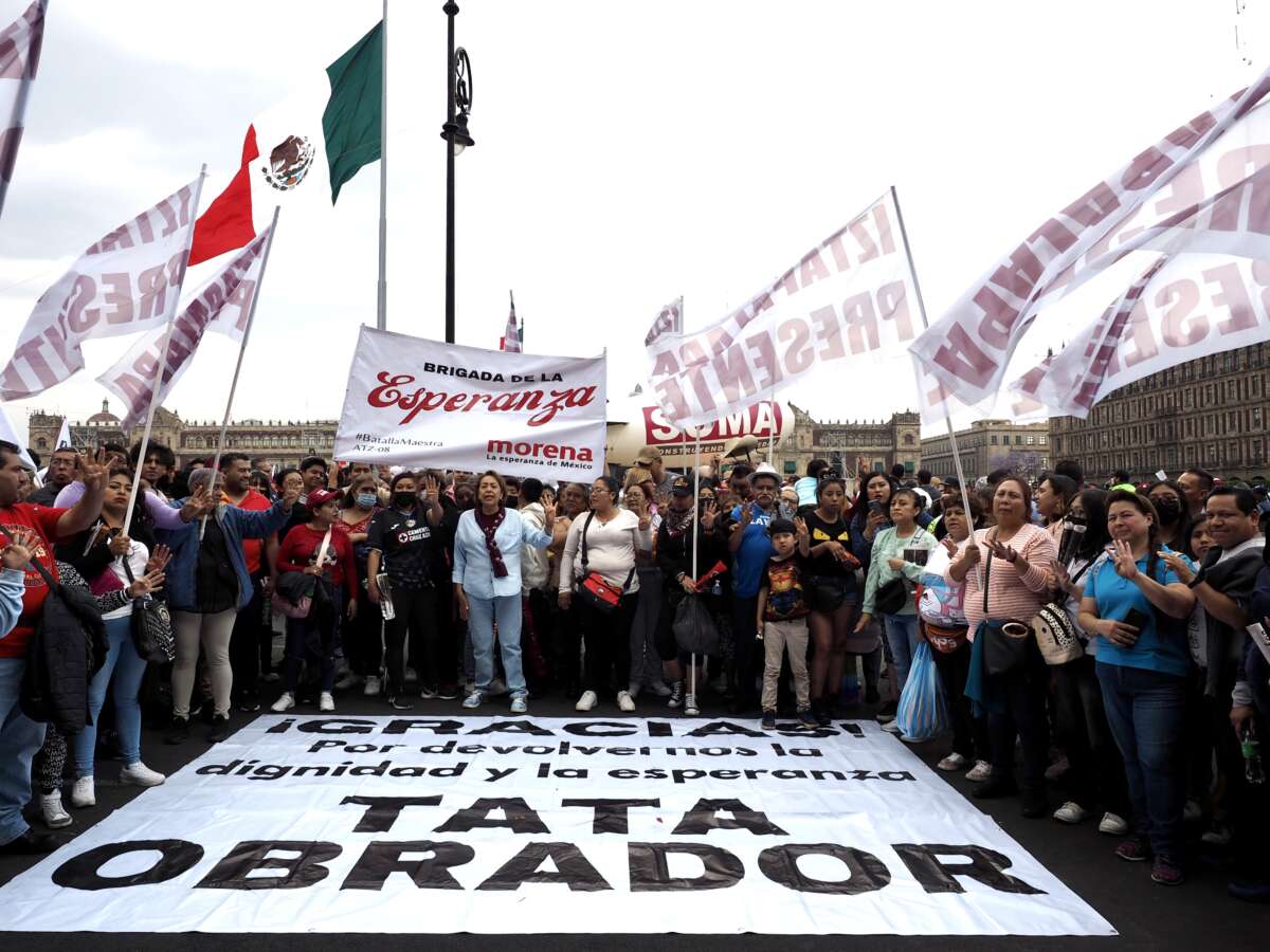 Inside Mexico City’s Zócalo, supporters of Mexico’s Andrés Manuel López Obrador stand before a sign that reads, 'Thank you for giving us hope and dignity back,' during a demonstration on March 18, 2023 to commemorate the 85th anniversary of the 1938 decree expropriating the oil industry.