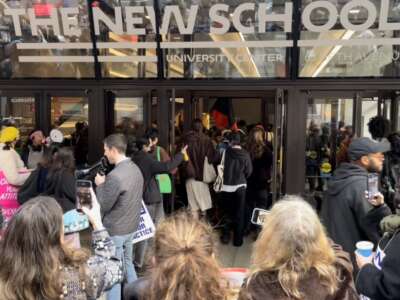 People throng outside the entrance of a building labeled "THE NEW SCHOOL"