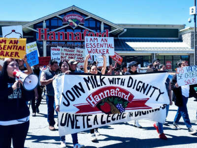 Farm workers march on a Hannaford Supermarket in Middlebury, Vermont, demanding “Milk with Dignity,” on May 1, 2022.