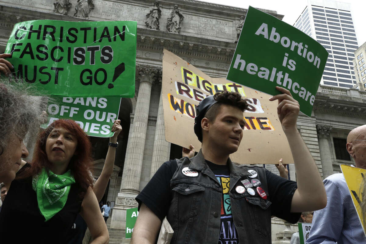 People protest against restricting abortion rights with signs in front of the New York Public Library on April 15, 2023 in New York City.