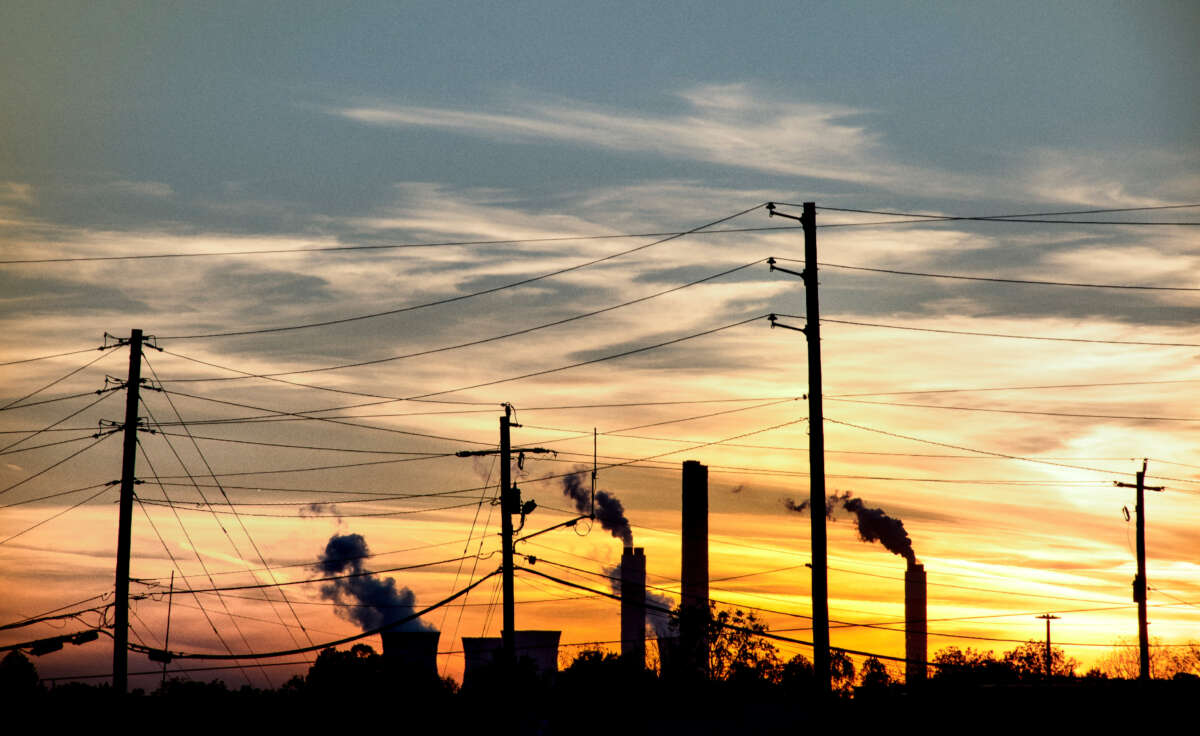 Sunset view of silhouetted smoke stacks with power lines in Tennessee