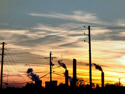 Sunset view of silhouetted smoke stacks with power lines in Tennessee