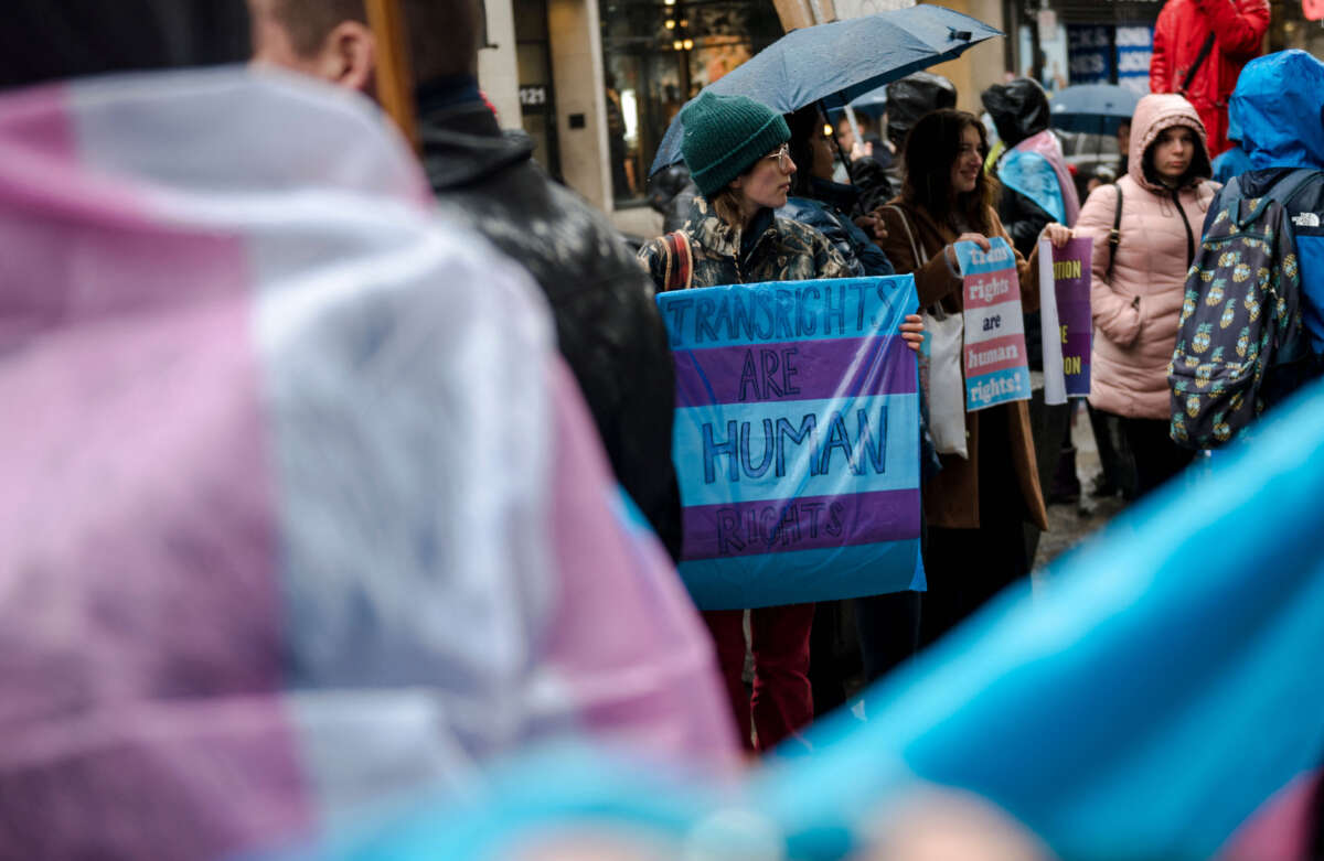 A person holds a sign reading 'Trans Rights are Human Rights' as LGBTQ activists protest on March 17, 2023, in front of the U.S. Consulate in Montreal, Canada.