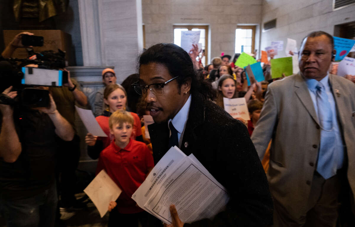 Democratic state Rep. Justin Jones enters the house chamber ahead of session as protesters chant demanding action for gun reform laws in the state at the Tennessee State Capitol on April 3, 2023, in Nashville, Tennessee.