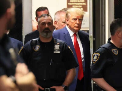 Donald Trump exits a building