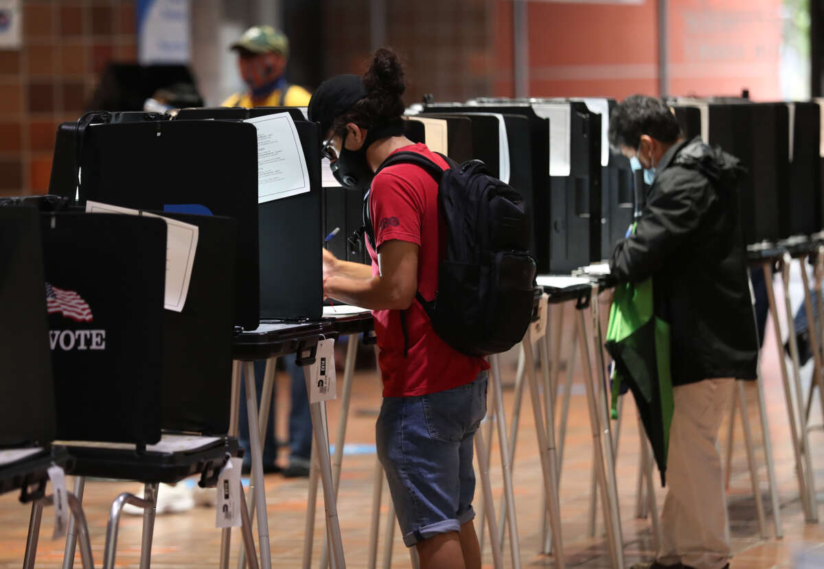 Voters fill out their ballots as they vote at the Stephen P. Clark Government Center polling station on October 21, 2020, in Miami, Florida.