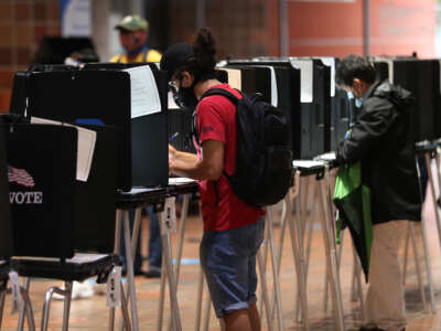 Voters fill out their ballots as they vote at the Stephen P. Clark Government Center polling station on October 21, 2020, in Miami, Florida.