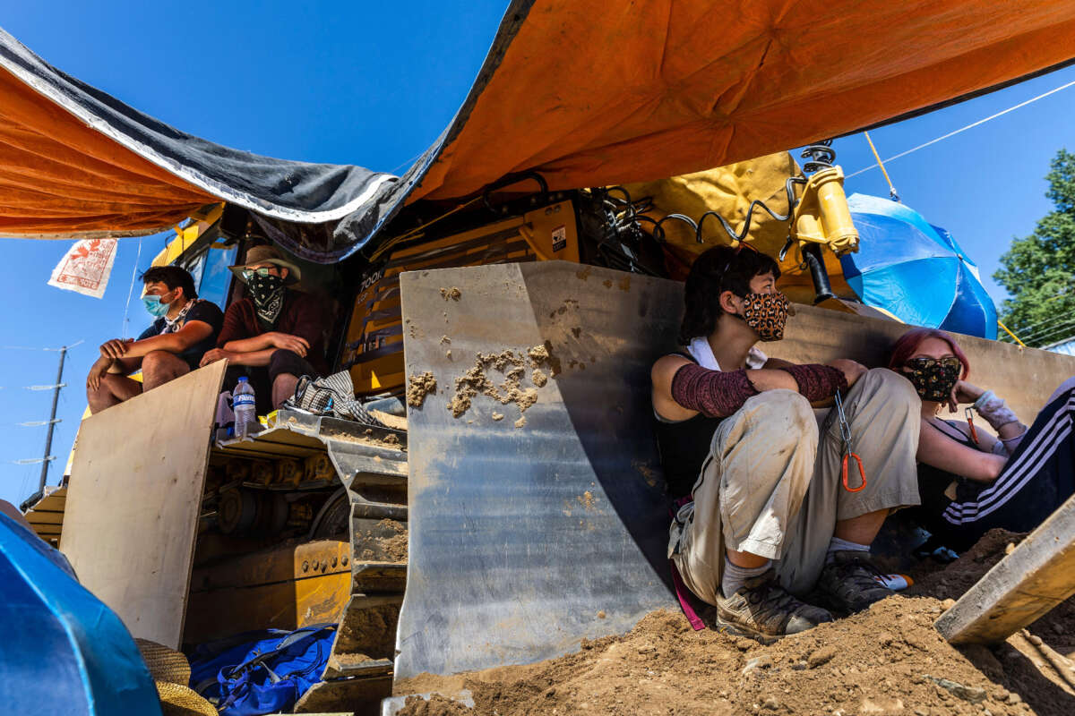 Environmental activists chain themselves to construction equipment at a Line 3 pipeline pumping station near Itasca State Park, Minnesota, on June 7, 2021.