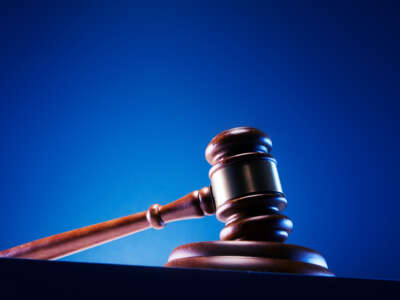 Judge's gavel against blue background