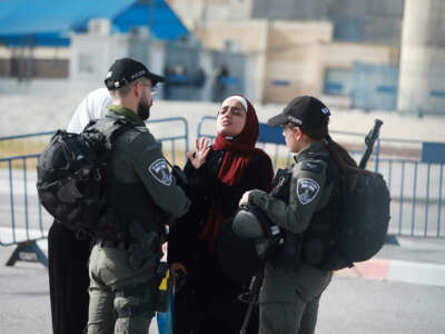 Two IDF officers harrass a young woman in a hijab