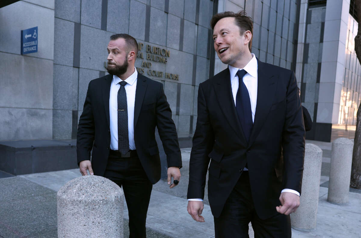 Tesla CEO Elon Musk (right) leaves the Phillip Burton Federal Building on January 24, 2023, in San Francisco, California.