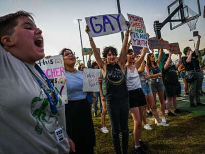 LGBTQ rights supporters protest against Florida Governor Ron Desantis outside a campaign event on November 6, 2022, in Fort Myers, Florida.